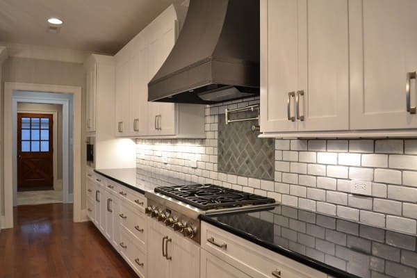 farmhouse kitchen with metal range hood